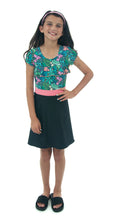 Load image into Gallery viewer, Swim Dress for Girls by Dressing For His Glory. Introduce your daughter to the Swim Dress, available in our Girls Sizes. Made with chlorine-resistant, UPF 50+ swimwear fabric, this dress is perfect for swimming and beach activities. Featuring a scooped neckline, cap sleeves, and a charming ruffle on the front yoke, the dress comes with attached bike shorts under the skirt for added comfort. Stay cool and stylish in this must-have piece.