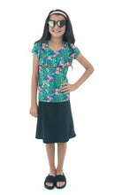 Load image into Gallery viewer, The Freestyle Swim Skirt is a high-performing swimwear option that combines style and functionality. Designed with a chlorine-resistant fabric that stretches and dries quickly, this skirt features attached bike shorts and an elastic waist for comfort and ease of movement.