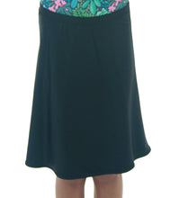 Load image into Gallery viewer, The Freestyle Swim Skirt is a high-performing swimwear option that combines style and functionality. Designed with a chlorine-resistant fabric that stretches and dries quickly, this skirt features attached bike shorts and an elastic waist for comfort and ease of movement.