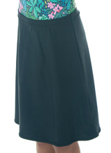 Load image into Gallery viewer, The Freestyle Swim Skirt is a high-performing swimwear option that combines style and functionality. Designed with a chlorine-resistant fabric that stretches and dries quickly, this skirt features attached bike shorts and an elastic waist for comfort and ease of movement.