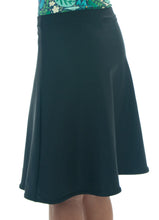 Load image into Gallery viewer, The Freestyle Swim Skirt is a high-performing swimwear option that combines style and functionality. Designed with a chlorine-resistant fabric that stretches and dries quickly, this skirt features attached bike shorts and an elastic waist for comfort and ease of movement.