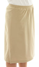 Load image into Gallery viewer, Side View: The Straight Skort for Junior Sizes by Dressing For His Glory is a straight cut skirt with loose fitting shorts underneath and are attached at the waist. It has slits on each side seam for easy leg movement and an elastic waistband. The shorts are made of the same fabric and are 1&quot; shorter than the outer layer skirt.